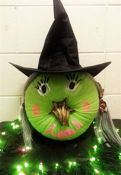 Pumpkin decorated like a witch with a hat